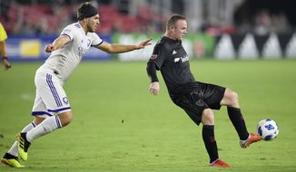 D.C. United forward Wayne Rooney, right, kicks the ball against Orlando City midfielder Dillon Powers, left, during the second half of an MLS soccer match, Sunday, Aug. 12, 2018, in Washington. D.C. United won 3-2. (AP Photo/Nick Wass) ** FILE **