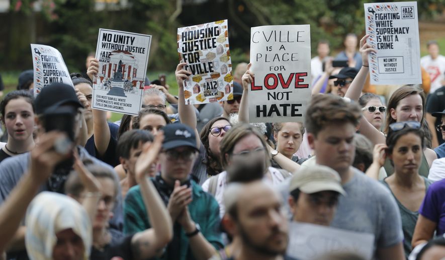 Demonstrators march on the campus of the University of Virginia in anticipation of the anniversary of last year&#39;s Unite the Right rally in Charlottesville, Va., Saturday, Aug. 11, 2018. (AP Photo/Steve Helber)