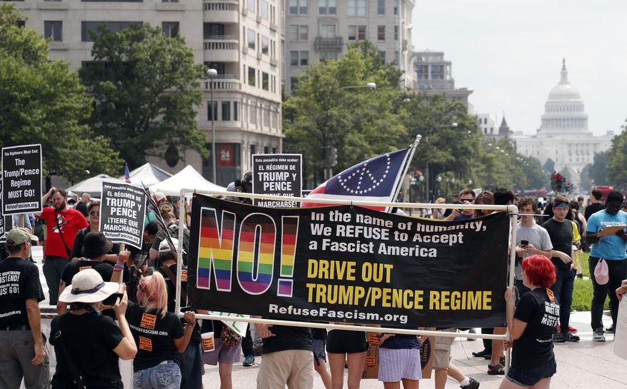 Groups protest in Freedom Plaza with the U.S. Capitol in the background, on the one year anniversary of Charlottesville&#39;s &amp;quot;Unite the Right&amp;quot; rally, Sunday, Aug. 12, 2018, in Washington. (AP Photo/Alex Brandon)