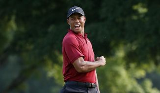 Tiger Woods celebrates after making a birdie putt on the 18th green during the final round of the PGA Championship golf tournament at Bellerive Country Club, Sunday, Aug. 12, 2018, in St. Louis. (AP Photo/Brynn Anderson) **FILE**