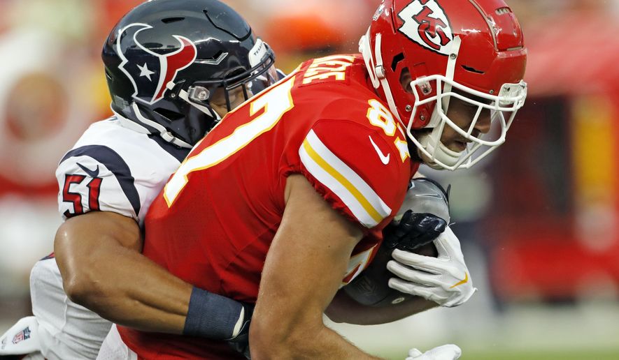 Houston Texans linebacker Dylan Cole (51) tackles Kansas City Chiefs tight end Travis Kelce (87) during the first half of an NFL preseason football game in Kansas City, Mo., Thursday, Aug. 9, 2018. (AP Photo/Colin E. Braley)