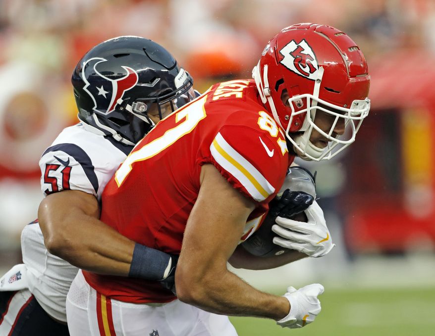 Houston Texans linebacker Dylan Cole (51) tackles Kansas City Chiefs tight end Travis Kelce (87) during the first half of an NFL preseason football game in Kansas City, Mo., Thursday, Aug. 9, 2018. (AP Photo/Colin E. Braley)