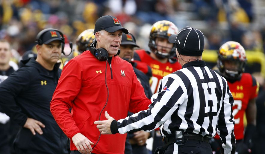 Maryland head coach DJ Durkin speaks with an official in the first half of an NCAA college football game against Michigan in College Park, Md., Saturday, Nov. 11, 2017. (AP Photo/Patrick Semansky) **FILE**