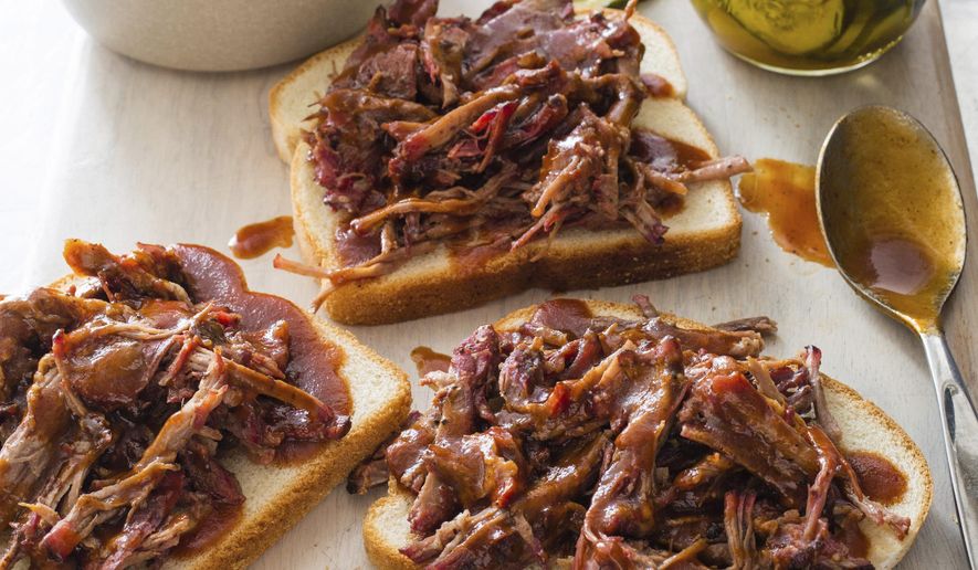 This undated photo provided by America's Test Kitchen in July 2018 shows shredded barbecued beef in Brookline, Mass. This recipe appears in “The Complete Cook’s Country TV Show Season 10 Cookbook.” (Carl Tremblay/America's Test Kitchen via AP)