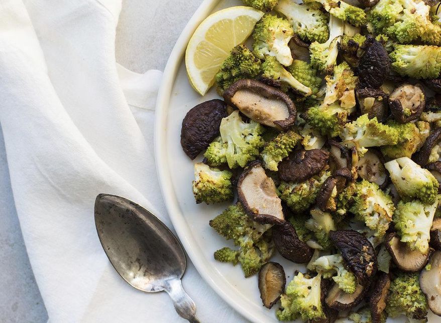 This February 2017 photo shows roasted broccoflower and shiitake mushrooms with rosemary and garlic in New York. This dish is from a recipe by Katie Workman. (Sarah Crowder via AP)