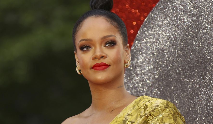 FILE - In this June 13, 2018 file photo, singer and actress Rihanna arrives at the premiere of "Ocean's 8" in central London. Rihanna’s fourth annual Diamond Ball will take place Sept. 13 at Cipriani Wall Street in New York. Global Citizen CEO Hugh Evans will receive the 2018 Diamond Ball Award. and "Insecure" actress Issa Rae will host. (Photo by Joel C Ryan/Invision/AP, File)