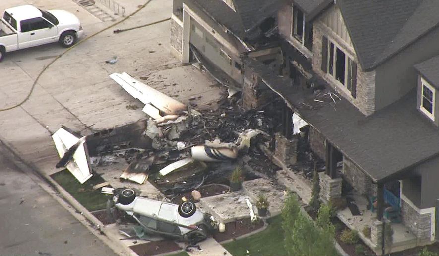 This frame from video shows the scene of a small plane that crashed into a house in Payson, Utah, on Monday, Aug 13, 2018. Authorities said the pilot was killed in the crash. (John Wilson/KSL-TV/Deseret News via AP)