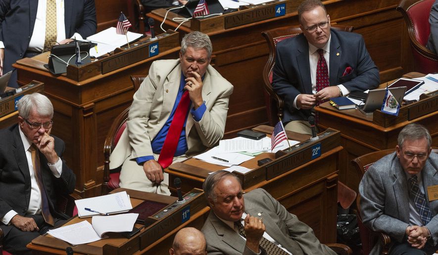 Delegates listen to a speaker during a special session of the state House of Delegates in Charleston, W.V., on Monday, Aug. 13, 2018. The delegates are voting on 15 articles of impeachment charges against Supreme Court Chief Justice Margaret Workman and Justices Robin Davis, Allen Loughry and Beth Walker. (Craig Hudson/Charleston Gazette-Mail via AP)