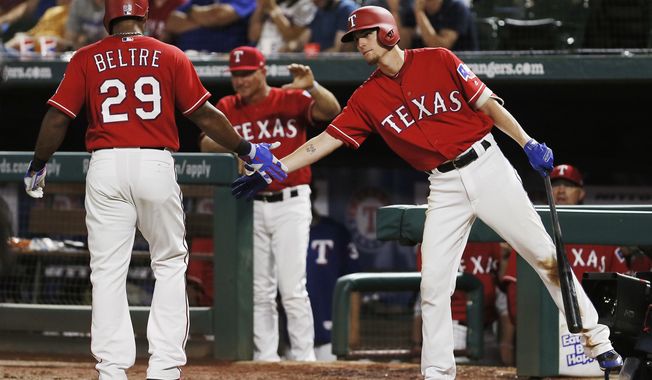 Texas Rangers&#x27; Adrian Beltre (29) is congratulated by Carlos Tocci, right, after scoring on an RBI single hit by Robinson Chirinos, not pictured, during the eighth inning of a baseball game against the Arizona Diamondbacks, Monday, Aug. 13, 2018, in Arlington, Texas. Texas won 5-3. (AP Photo/Brandon Wade)