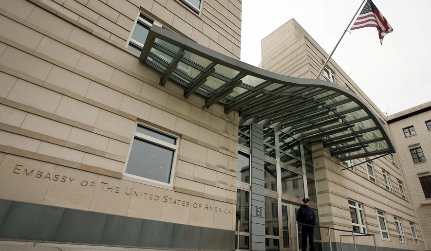 FILE - In this Oct. 25, 2013 file photo the US flag flies at the main entrance of the US embassy in Berlin. Berlin police say threatening letters containing a white powder have been sent to both the American and Israeli embassies in the German capital. (AP Photo/Michael Sohn, file)