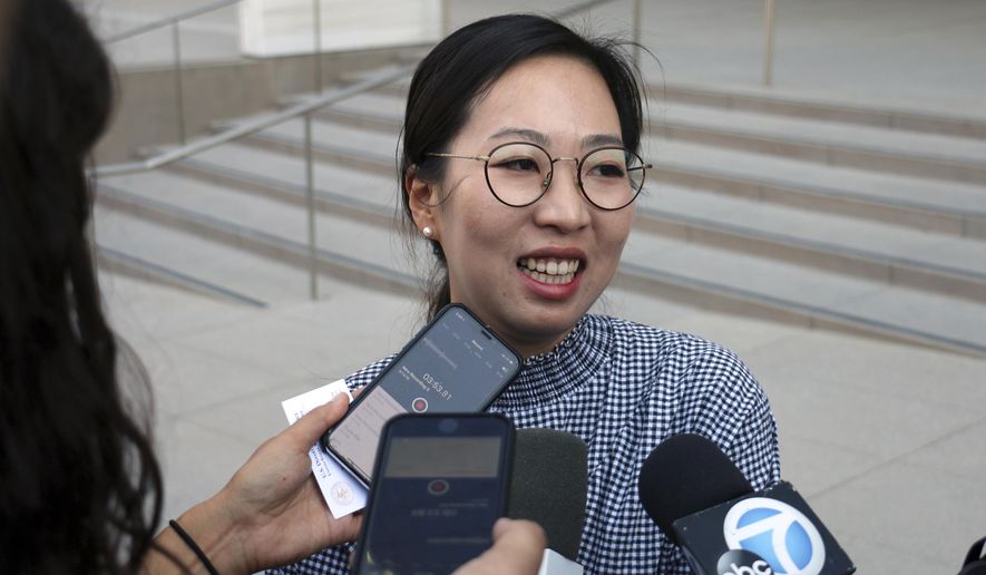 Yea Ji Sea, a former U.S. Army specialist who was born in South Korea, talks with reporters after a federal court hearing in Los Angeles Tuesday, Aug. 14, 2018. Sea filed a lawsuit in July, 2018, demanding a response to her citizenship application after the military moved to discharge her. She has since been discharged. U.S. District Judge Michael Fitzgerald says the government will have to rule on Sea&#x27;s application by Sept. 5 or explain the delay to the court. (AP Photo/Ariel Tu)