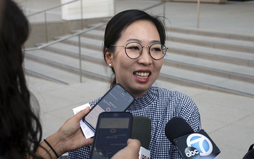 Yea Ji Sea, a former U.S. Army specialist who was born in South Korea, talks with reporters after a federal court hearing in Los Angeles Tuesday, Aug. 14, 2018. Sea filed a lawsuit in July, 2018, demanding a response to her citizenship application after the military moved to discharge her. She has since been discharged. U.S. District Judge Michael Fitzgerald says the government will have to rule on Sea's application by Sept. 5 or explain the delay to the court. (AP Photo/Ariel Tu)