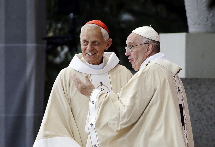 In this Sept. 23, 2015, file photo, Cardinal Donald Wuerl, archbishop of Washington, left, looks toward the crowd with Pope Francis following a Mass outside the Basilica of the National Shrine of the Immaculate Conception in Washington. Wuerl wrote to priests to defend himself on the eve of the scheduled Tuesday, Aug. 14, 2018, release of a grand jury report investigating child sexual abuse in six of Pennsylvania's Roman Catholic dioceses. (AP Photo/David Goldman, File)