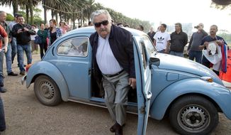 FILE - In this Oct. 26, 2014 file photo, Uruguay&#39;s former President Jose Mujica arrives to cast his vote in Montevideo, Uruguay. Mujica resigned on Tuesday, Aug. 14, 2018, from the senator&#39;s bench he won in the 2014 elections and in which he had the right to remain until March 2020. (AP Photo/Natacha Pisarenko, File)
