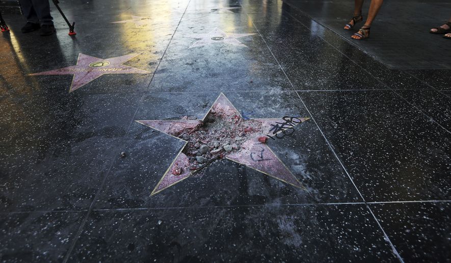 FILE - This photo July 25, 2018 file photo shows Donald Trump's star on the Hollywood Walk of Fame that was vandalized, in Los Angeles. The man accused of smashing Trump's star says his actions were a "rightful and just act." Austin Clay pleaded not guilty to a felony vandalism charge in Los Angeles, Wednesday, Aug. 15, 2018. (AP Photo/Reed Saxon, File)