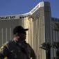 A Las Vegas police officer stands by a blocked off area near the Mandalay Bay casino following a mass shooting in Las Vegas.  (AP Photo/John Locher, File)