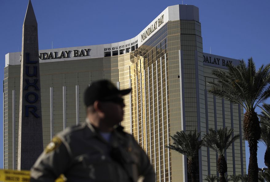 A Las Vegas police officer stands by a blocked off area near the Mandalay Bay casino following a mass shooting in Las Vegas.  (AP Photo/John Locher, File)