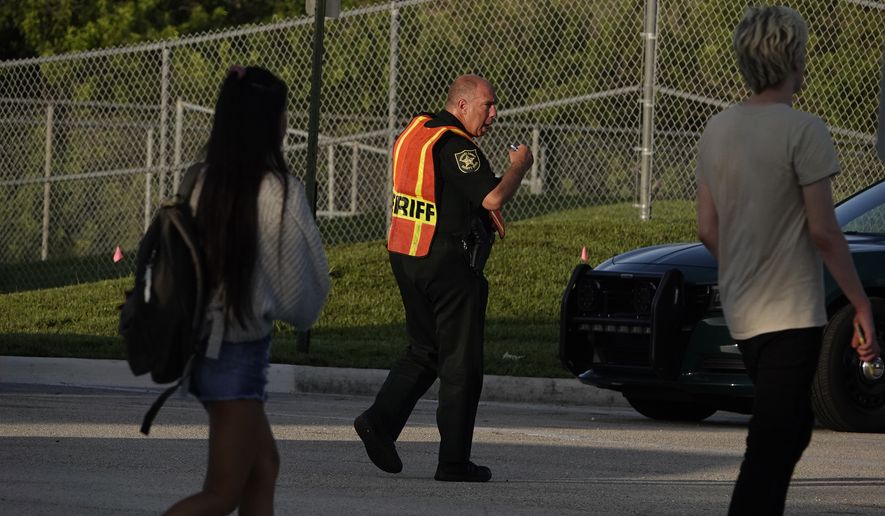 A Broward County sheriff&#x27;s deputy was on hand Wednesday as students arrived at Marjory Stoneman Douglas High School in Parkland, Florida, for the first day of classes. (Associated Press/File)