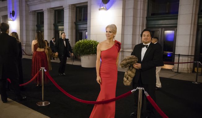 In this Thursday, Jan. 19, 2017, file photo, President-elect Donald Trump adviser Kellyanne Conway, center, accompanied by her husband, George, speaks with members of the media as they arrive for a dinner at Union Station in Washington, the day before Trump&#x27;s inauguration. (AP Photo/Matt Rourke) ** FILE **