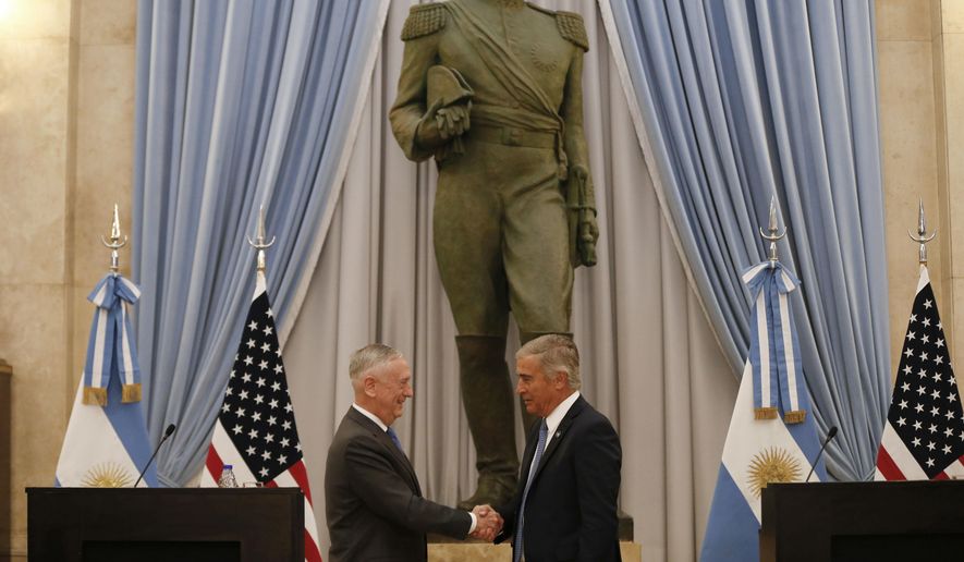 U.S. Secretary of Defense Jim Mattis, left, and Argentina&#39;s Defense Minister Oscar Raul Aguad shake hands in Buenos Aires, Argentina Wednesday, Aug. 15, 2018. Mattis is on an official visit to several South American countries. (AP Photo/Natacha Pisarenko)