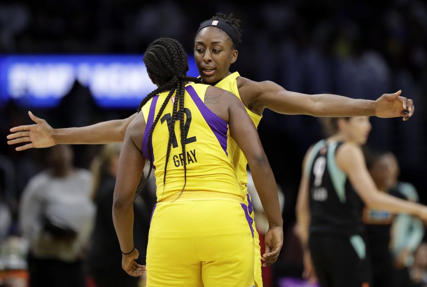 Los Angeles Sparks' Nneka Ogwumike, center right, celebrates after scoring with teammate Chelsea Gray (12) during the second half of a WNBA basketball game against the New York Liberty, Tuesday, Aug. 14, 2018, in Los Angeles. (AP Photo/Marcio Jose Sanchez)
