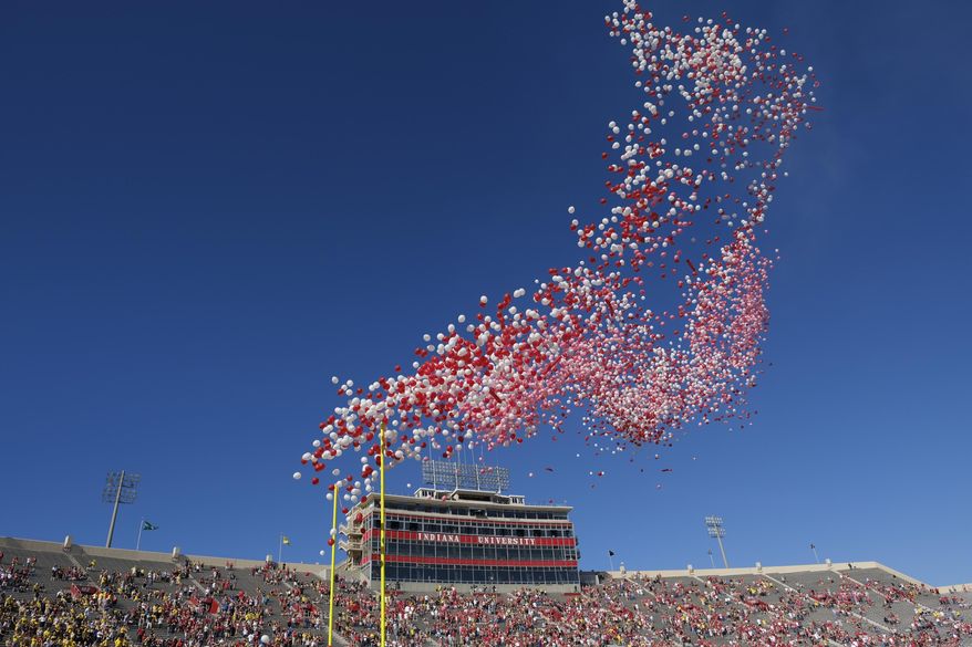 In this Oct. 14, 2017, file photo balloons are released in Memorial Stadium before an NCAA college football game between Indiana and Michigan in Bloomington, Ind. The celebration of releasing balloons into the air has long bothered environmentalists, who say the pieces that fall back to earth can be deadly to seabirds and turtles that eat them. So as companies vow to banish plastic straws, there are signs balloons are among the products getting more scrutiny. (AP Photo/AJ Mast, File)