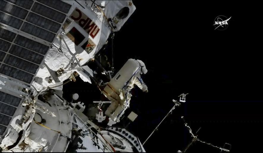 In this image made from video provided by NASA, cosmonaut Sergey Prokopyev flings a Sirius nano-satellite into orbit from the International Space Station on Wednesday, Aug. 15, 2018. (NASA via AP)