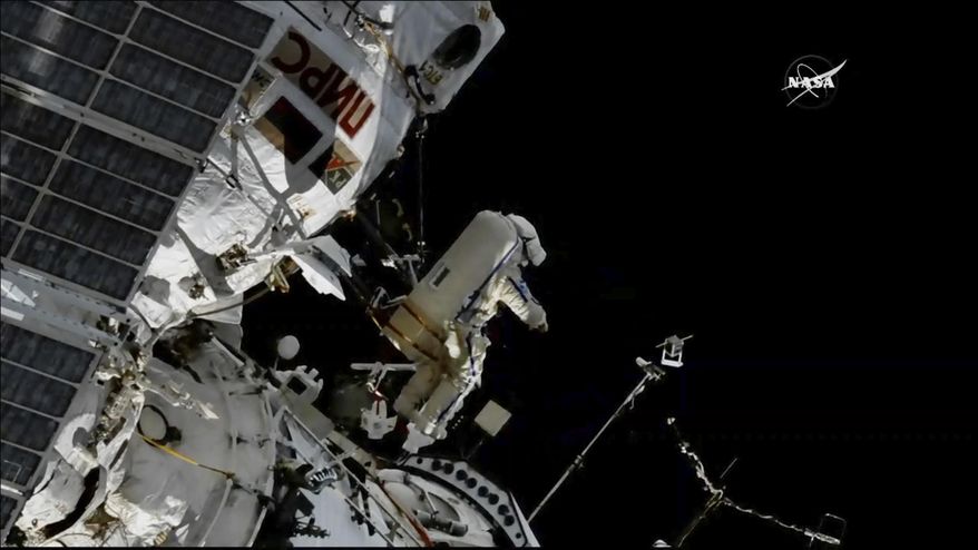 In this image made from video provided by NASA, cosmonaut Sergey Prokopyev flings a Sirius nano-satellite into orbit from the International Space Station on Wednesday, Aug. 15, 2018. (NASA via AP)
