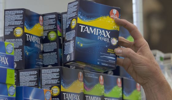 Tammy Compton restocks tampons at Compton&#x27;s Market, Wednesday, June 22, 2016, in Sacramento, Calif. A bill to exempt tampons and feminine hygiene products from sales tax co-authored by Assemblywomen Cristina Garcia, D-Bell Gardens and Ling Ling Chang, R-Diamond Bar, was approved by the Senate Governance and Finance committee Wednesday. (AP Photo/Rich Pedroncelli) ** FILE **