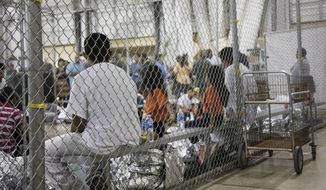 In this June 17, 2018, file photo provided by U.S. Customs and Border Protection, people who&#39;ve been taken into custody related to cases of illegal entry into the United States, sit in one of the cages at a facility in McAllen, Texas. (U.S. Customs and Border Protection&#39;s Rio Grande Valley Sector via AP) ** FILE **
