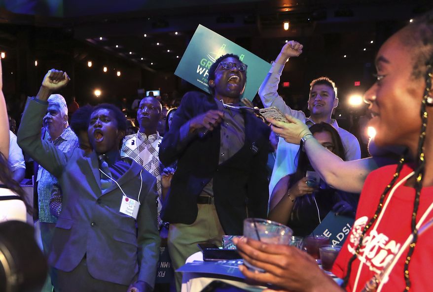 Supporters cheer as Michigan Democratic gubernatorial candidate Gretchen Whitmer is declared the winner in the primary, Tuesday, Aug. 7, 2018, in Detroit. Whitmer will face Republican Bill Schuette in November. (AP Photo/Carlos Osorio)