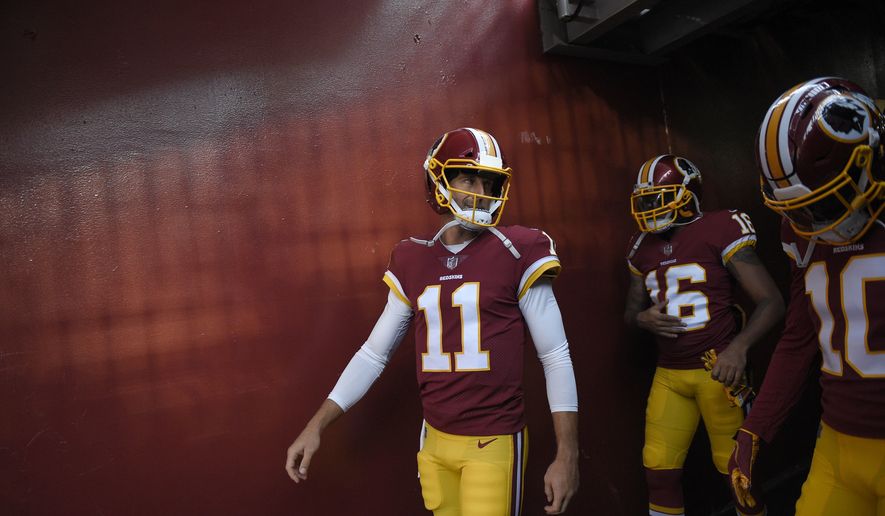 Washington Redskins quarterback Alex Smith (11) walks in the tunnel next to wide receiver Shay Fields (16) and wide receiver Paul Richardson (10) before the team's preseason NFL football game against the New York Jets, Thursday, Aug. 16, 2018, in Landover, Md. (AP Photo/Nick Wass)