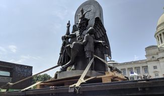 The Satanic Temple unveils its statue of Baphomet, a winged-goat creature, at a rally for the First Amendment in Little Rock, Ark., Thursday, Aug. 16, 2018. The Satanic Temple wants to install the statue on Capitol grounds as a symbol for religious freedom after a monument of the Biblical Ten Commandments was installed in 2017. (AP Photo/Hannah Grabenstein) ** FILE **