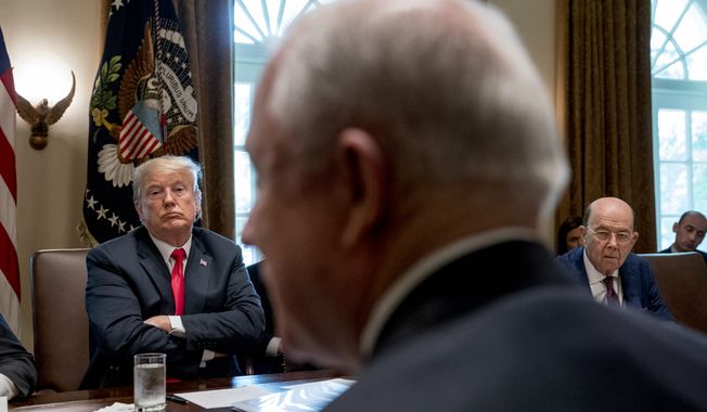 President Donald Trump, left, listens as Attorney General Jeff Sessions, foreground, speaks during a cabinet meeting in the Cabinet Room of the White House, Thursday, Aug. 16, 2018, in Washington. Also pictured is Commerce Secretary Wilbur Ross, right. (AP Photo/Andrew Harnik)