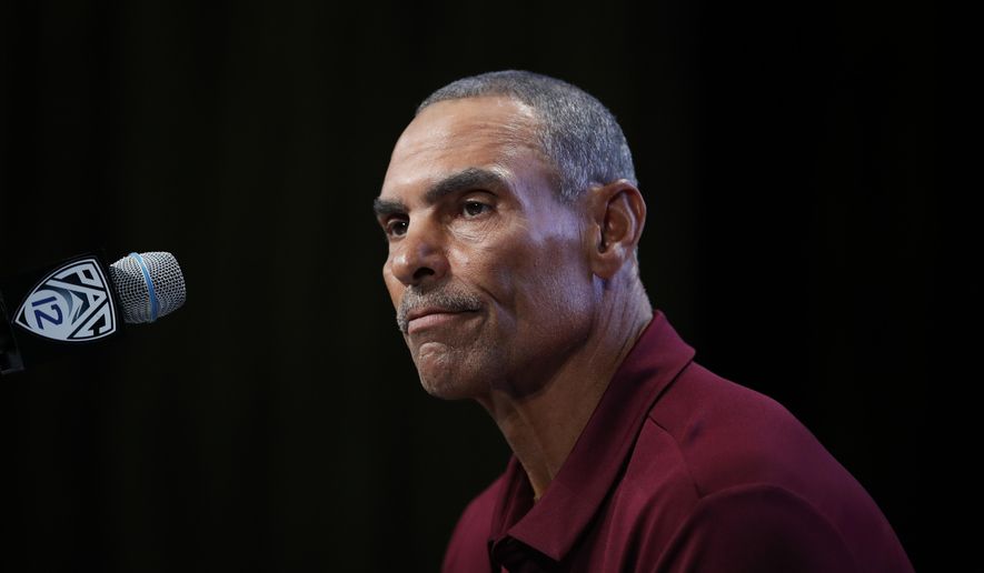 File- This July 25, 2018, file photo shows Arizona State head coach Herm Edwards pausing while speaking at the Pac-12 Conference NCAA college football Media Day in Los Angeles. Since Edwards' surprising hiring, the 64-year-old coach has shut out the outside noise, kept his focus on football and family as he tries to raise Arizona State to among the Pac-12 elite. "I don't concern myself with the outside elements because the outside elements don't coach the team," he said. "I've got to coach coaches and players, and that's my obligation. I've got to stay focused on that."(AP Photo/Jae C. Hong, File)