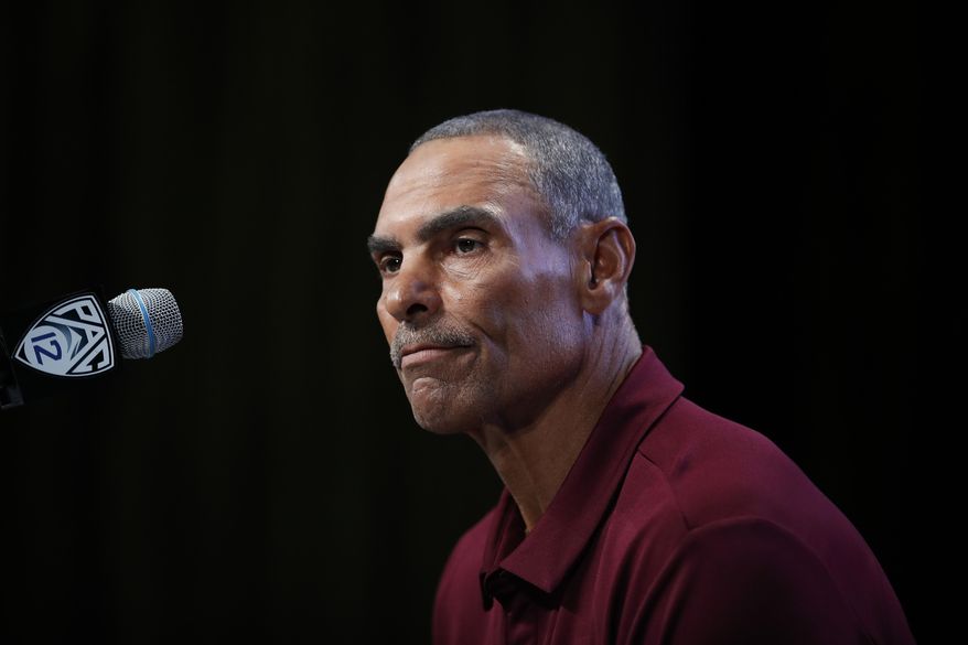 File- This July 25, 2018, file photo shows Arizona State head coach Herm Edwards pausing while speaking at the Pac-12 Conference NCAA college football Media Day in Los Angeles. Since Edwards' surprising hiring, the 64-year-old coach has shut out the outside noise, kept his focus on football and family as he tries to raise Arizona State to among the Pac-12 elite. "I don't concern myself with the outside elements because the outside elements don't coach the team," he said. "I've got to coach coaches and players, and that's my obligation. I've got to stay focused on that."(AP Photo/Jae C. Hong, File)