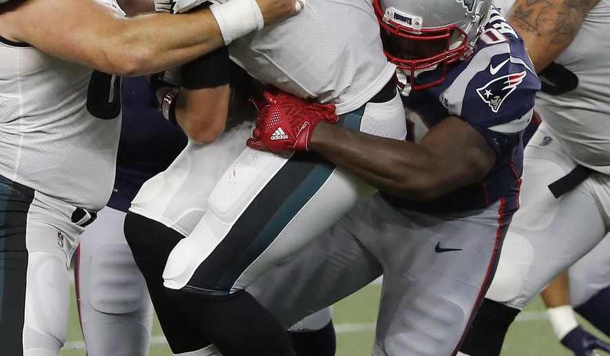New England Patriots defensive tackle Adam Butler, right, sacks Philadelphia Eagles quarterback Nick Foles during the first half of a preseason NFL football game, Thursday, Aug. 16, 2018, in Foxborough, Mass. (AP Photo/Mary Schwalm)