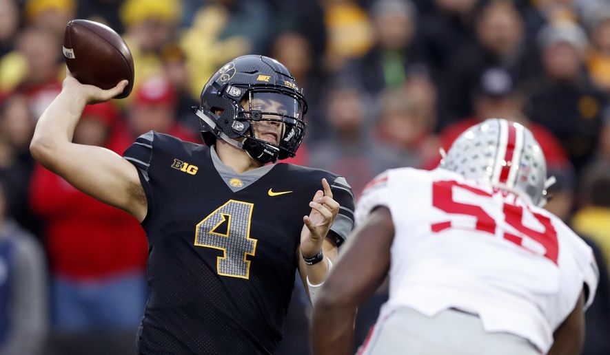 FILE - In this Nov. 4, 2017, file photo, Iowa quarterback Nate Stanley (4) throws a pass during the second half of an NCAA college football game against Ohio State, Saturday, Nov. 4, 2017, in Iowa City, Iowa. Entering 2018, Iowa looks like it usually does in August, as a decent team with a chance to be a special one. (AP Photo/Charlie Neibergall, File)