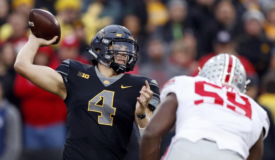 FILE - In this Nov. 4, 2017, file photo, Iowa quarterback Nate Stanley (4) throws a pass during the second half of an NCAA college football game against Ohio State, Saturday, Nov. 4, 2017, in Iowa City, Iowa. Entering 2018, Iowa looks like it usually does in August, as a decent team with a chance to be a special one. (AP Photo/Charlie Neibergall, File)