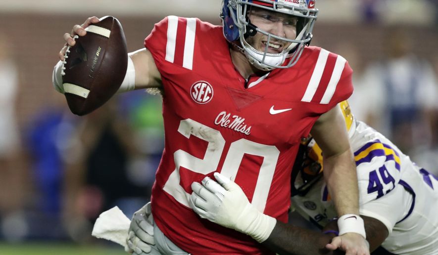 File This Oct. 21, 2017, file photo shows then Mississippi quarterback Shea Patterson (20) being sacked by LSU linebacker Arden Key (49) in the second half of an NCAA college football game in Oxford, Miss. Home games against Penn State and Wisconsin also present challenges for Michigan and former Ole Miss starter Patterson. Patterson is expected to be the team’s quarterback even though Harbaugh insists there’s still an open competition for the job. (AP Photo/Rogelio V. Solis, File)