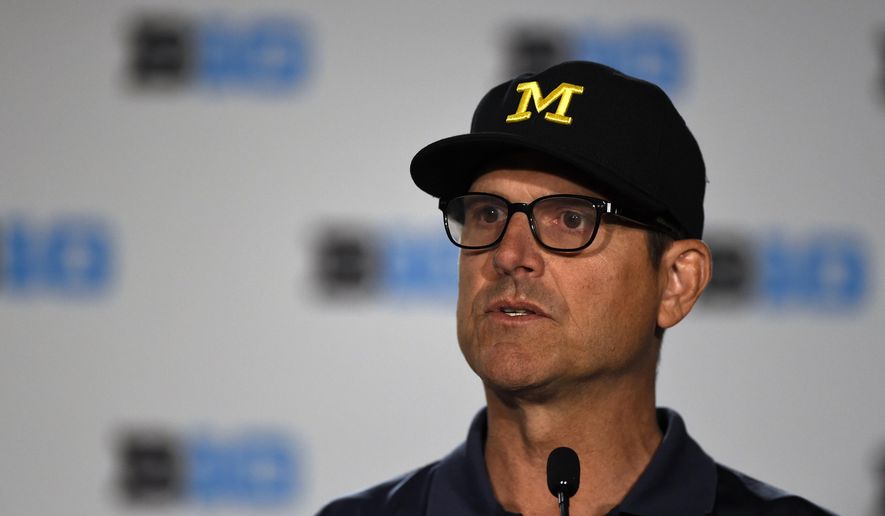 File-This July 23, 2018, file photo shows Michigan head coach Jim Harbaugh speaking at the Big Ten Conference NCAA college football Media Days in Chicago. Harbaugh is in his fourth year, giving him time to assemble perhaps his best team. The Wolverines, though, may be hard pressed to match the 10-win seasons Harbaugh had in his first two years. (AP Photo/Annie Rice, File)