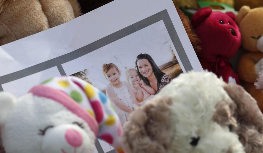 A photograph sits amid the tributes as they grow outside the home where a pregnant woman, Shanann Watts, and her two daughters, Bella and Celeste, lived Thursday, Aug. 16, 2018, in Frederick, Colo. The woman&#39;s husband, Christopher Watts, has been arrested on suspicion of killing his family. (AP Photo/David Zalubowski)