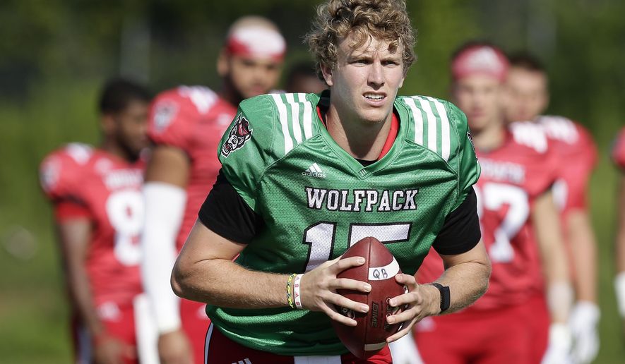 In this photo taken Thursday, Aug. 9, 2018, North Carolina State quarterback Ryan Finley runs through a drill during an NCAA college football practice in Raleigh, N.C. (AP Photo/Gerry Broome)