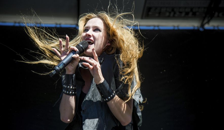 FILE - In this Sept. 24, 2016 file photo, Jill Janus of Huntress performs at Ozzfest 2016 at San Manuel Amphitheater in San Bernardino, Calif. Janus, lead singer of the heavy metal band Huntress, has died at age 43. A statement from Janus' bandmates and family released Thursday, Aug. 16, 2018, through publicist Alexandra Greenberg said Janus had long struggled with mental illness, and killed herself outside Portland, Ore., on Tuesday, Aug. 14. (Amy Harris/Invision/AP, File)