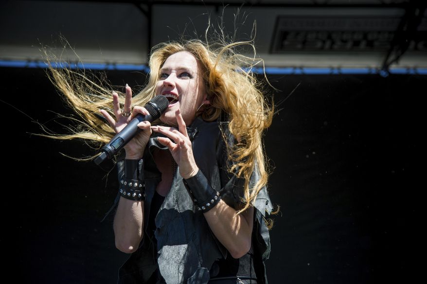 FILE - In this Sept. 24, 2016 file photo, Jill Janus of Huntress performs at Ozzfest 2016 at San Manuel Amphitheater in San Bernardino, Calif. Janus, lead singer of the heavy metal band Huntress, has died at age 43. A statement from Janus' bandmates and family released Thursday, Aug. 16, 2018, through publicist Alexandra Greenberg said Janus had long struggled with mental illness, and killed herself outside Portland, Ore., on Tuesday, Aug. 14. (Amy Harris/Invision/AP, File)