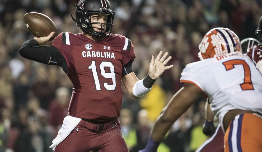 FILE - In this Saturday, Nov. 25, 2017, file photo, South Carolina quarterback Jake Bentley (19) attempts a pass against Clemson defensive end Austin Bryant (7) during the first half of an NCAA college football game, in Columbia, S.C. (AP Photo/Sean Rayford, File)