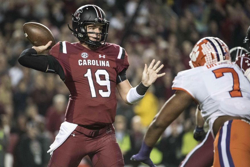 FILE - In this Saturday, Nov. 25, 2017, file photo, South Carolina quarterback Jake Bentley (19) attempts a pass against Clemson defensive end Austin Bryant (7) during the first half of an NCAA college football game, in Columbia, S.C. (AP Photo/Sean Rayford, File)