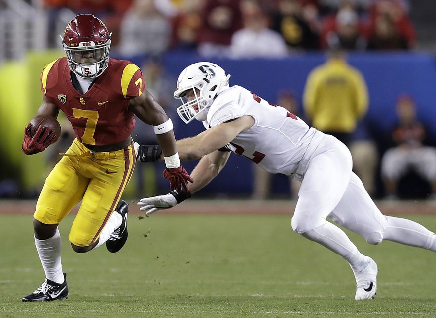 FILE - In this Dec. 1, 2017, file photo, Southern California running back Stephen Carr (7) runs against Stanford linebacker Joey Alfieri (32) during the first half of the Pac-12 Conference championship NCAA college football game in Santa Clara, Calif. (AP Photo/Marcio Jose Sanchez, File)