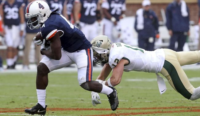 File-This Sept. 2, 2017, file photo shows Virginia running back Olamide Zaccheaus, left, running past William & Mary safety Mike Barta, right, during an NCAA college football game  in Charlottesville, Va. Zaccheaus set a school single-season record last season with 85 catches. They went for 895 yards and five touchdowns, and Mendenhall has challenged him to do more this year. Some of that may come in the running game, but Zaccheaus said another area of emphasis is improving his yards after the catch.  (Andrew Shurtleff /The Daily Progress via AP, File)