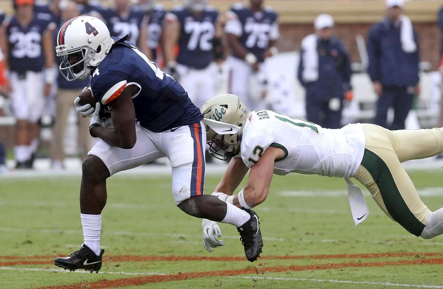 File-This Sept. 2, 2017, file photo shows Virginia running back Olamide Zaccheaus, left, running past William & Mary safety Mike Barta, right, during an NCAA college football game in Charlottesville, Va. Zaccheaus set a school single-season record last season with 85 catches. They went for 895 yards and five touchdowns, and Mendenhall has challenged him to do more this year. Some of that may come in the running game, but Zaccheaus said another area of emphasis is improving his yards after the catch. (Andrew Shurtleff /The Daily Progress via AP, File)